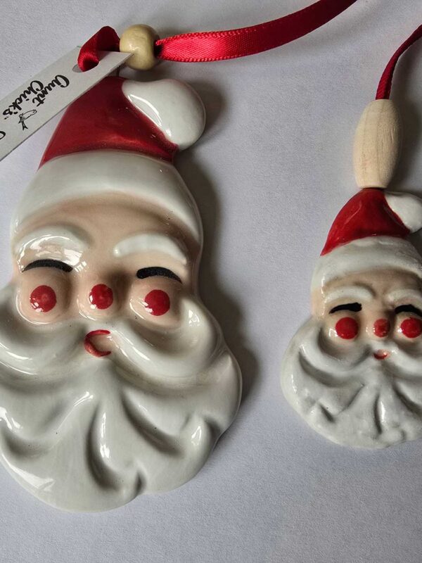 Two Jolly Santa Ornaments showing size difference